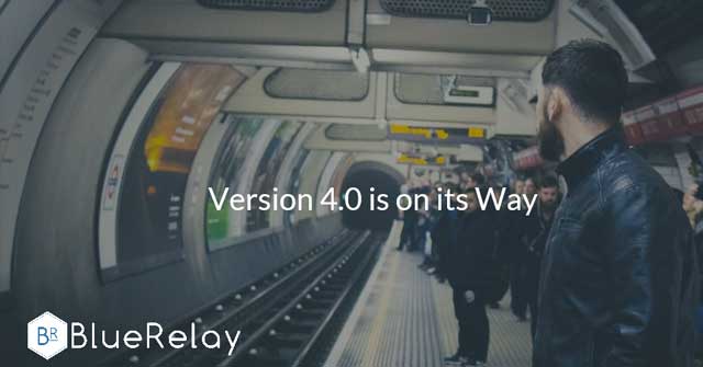 Image of a subway platform looking towards the subway tunnel, with various people waiting for a subway train